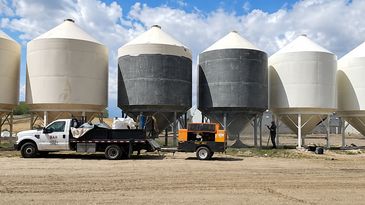 Industrial storage tanks with a truck and equipment.