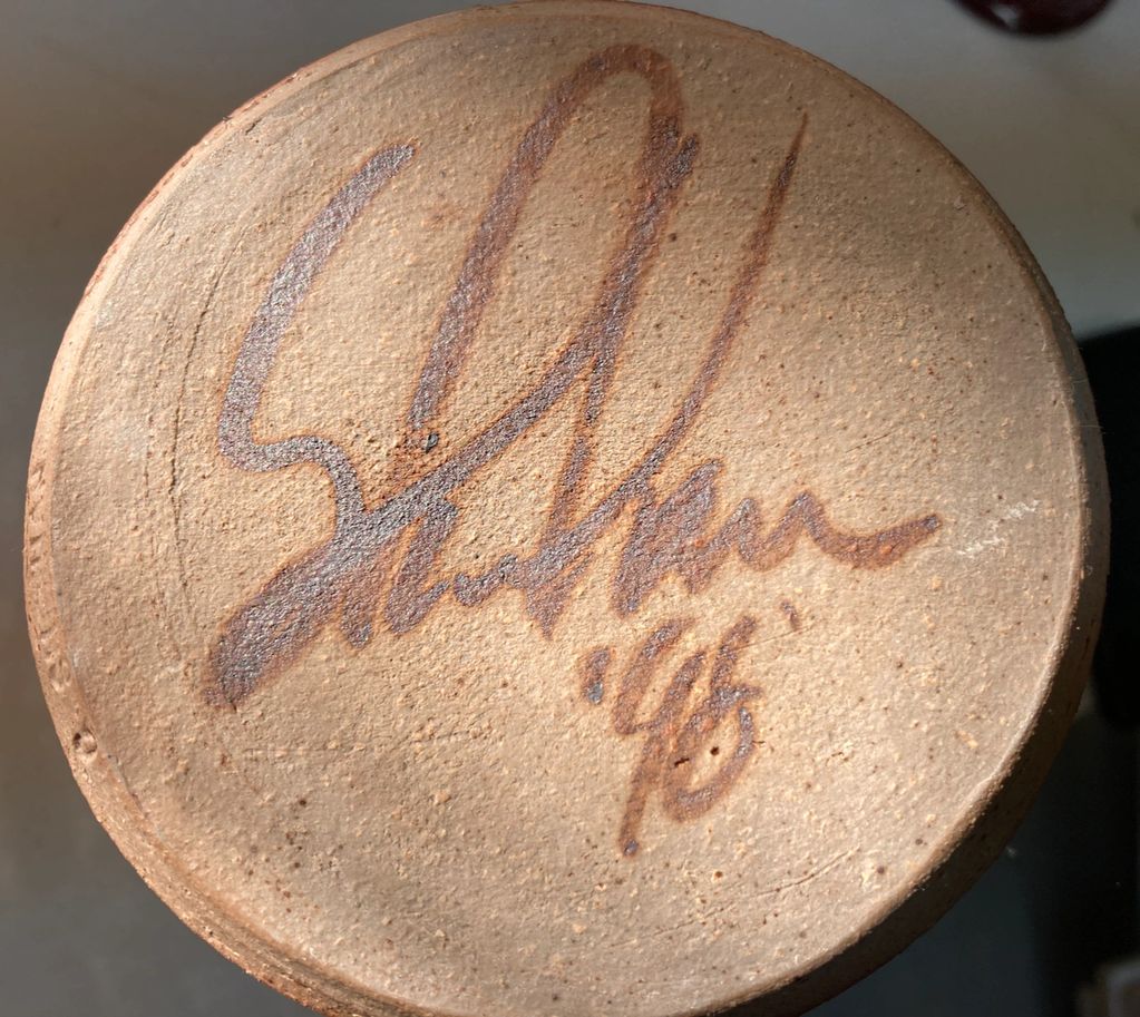 Bottom of a Mug signed Sheehan '98.