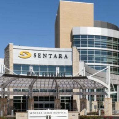 A modern hospital building with a glass and stone facade, Sentara Leigh Hospital