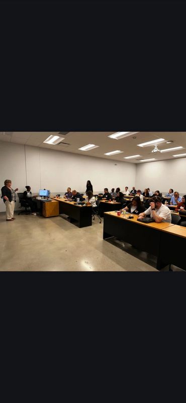 People attending a classroom training with a presenter speaking.