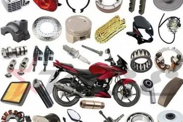 Various motorcycle parts surrounding a red motorcycle.