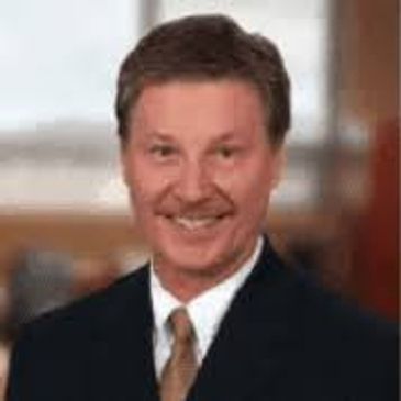 Professional man in suit smiling at camera.
