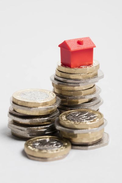 Housing cost. Red house with British currency