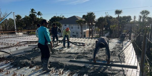 Concrete foundation and slab installation for residential shell construction in Fort Myers, Florida.