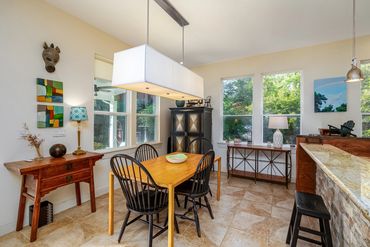 Butcher block dining table and black Windsor style chairs