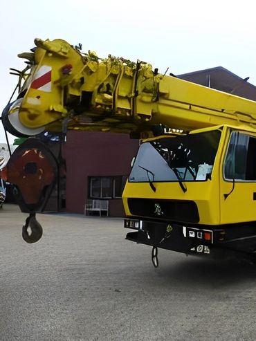 A digitally rendered yellow mobile crane with multiple wheels