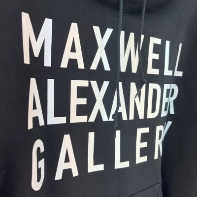 Black hoodie with bold white text saying Maxwell Alexander Gallery.
