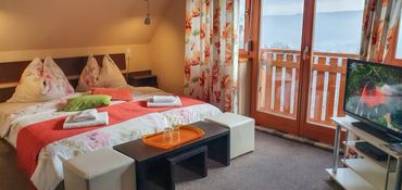 Cozy bedroom with floral decor and balcony view.