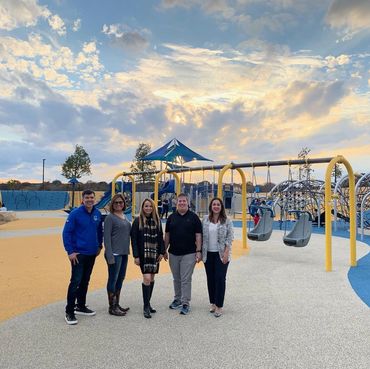 Dylan and friends posing for a group photo in front an inclusive playground in Plano, TX.