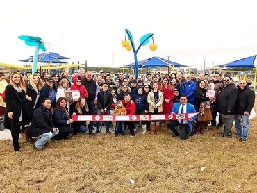 A large group photo for a grand opening of an all-abilities playground in McAllen, TX.