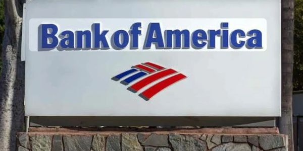 Bank of America sign with logo on a stone base outdoors.