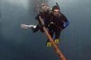PADI Diver decending down a rope
