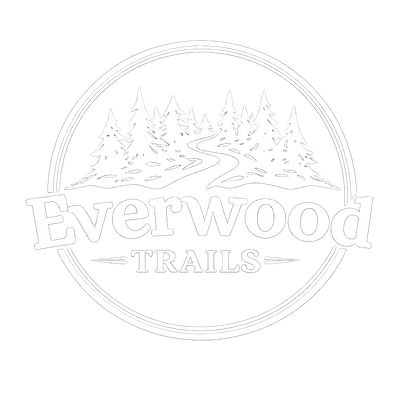 Logo of Everwood Trails featuring pine trees and a winding path.