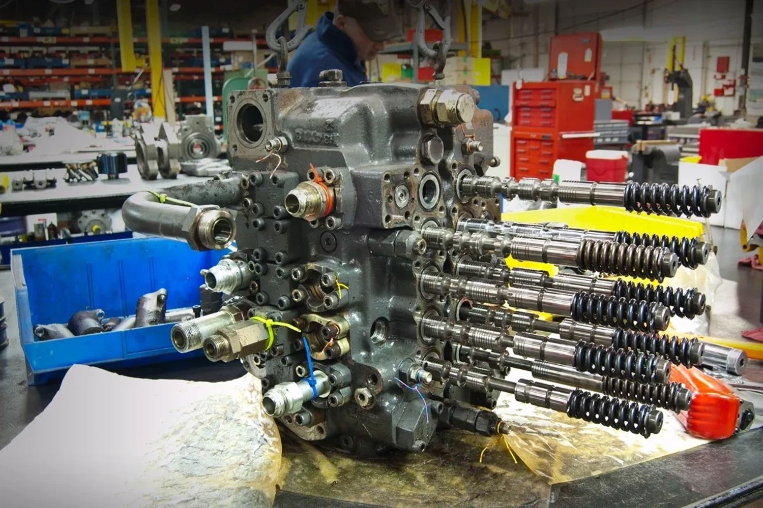 A complex hydraulic valve assembly in an industrial workshop.