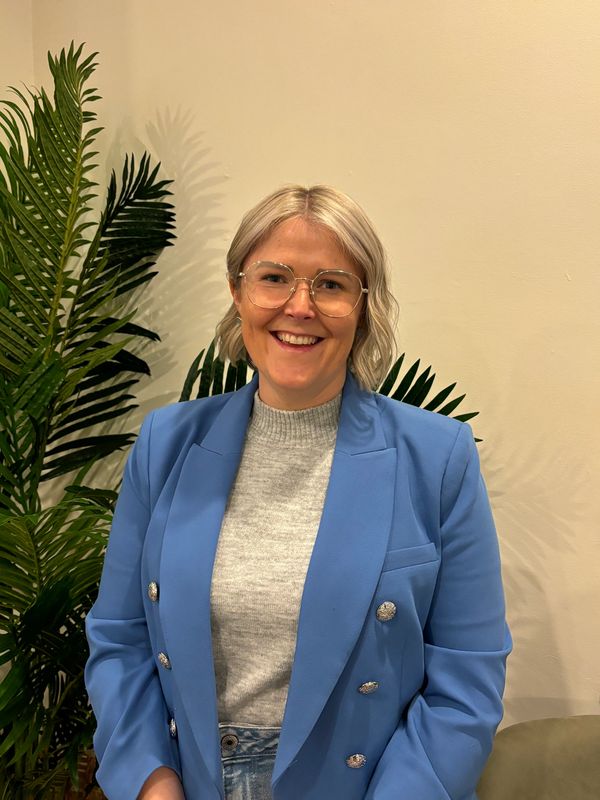 Photograph mid-shot of Karina smiling.