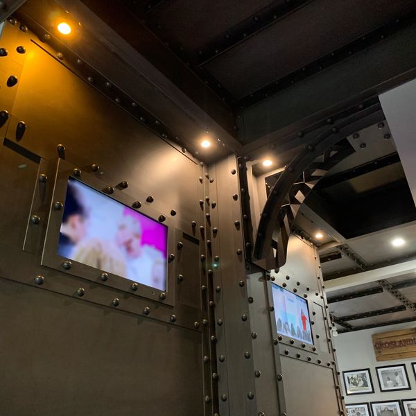 An industrial steel design with mounted televisions