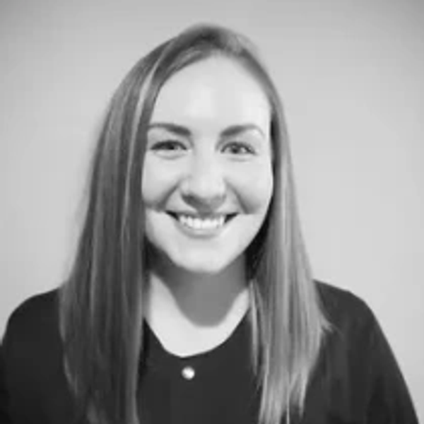 Black and white portrait of a smiling woman with straight hair.