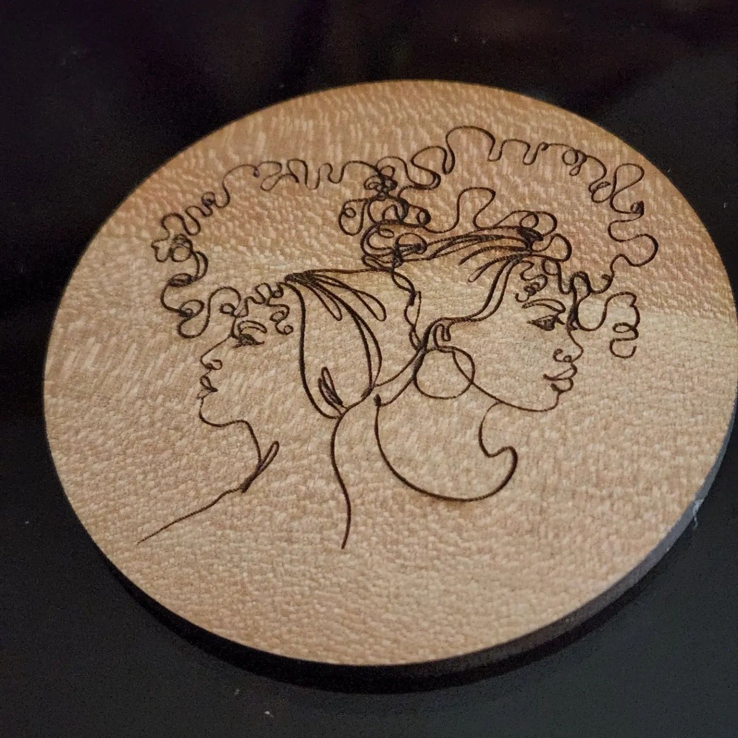 Mini coaster with line drawing of ladies