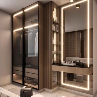 Modern bedroom vanity with illuminated mirror and glass wardrobe.