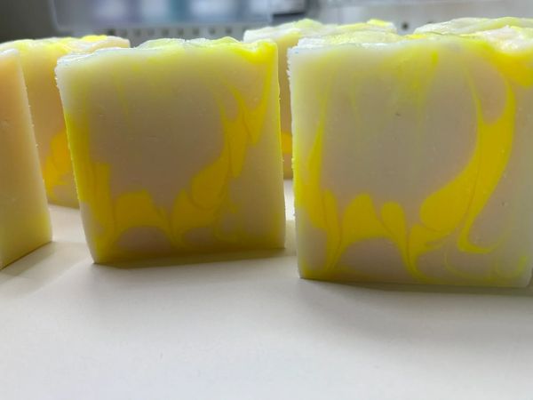 Handmade soap bars with yellow and white swirls.