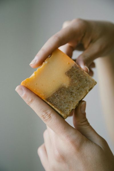 Hands holding a two-toned bar of soap.