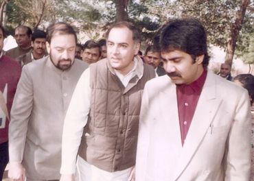 Group of men walking outdoors, engaged in conversation.