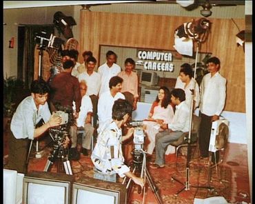 A vintage TV show set with a group filming "Computer Careers".