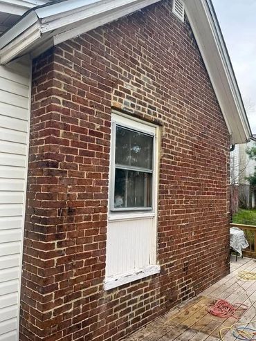 Brick gable wall with stained, worn mortar joints, Richmond VA – before