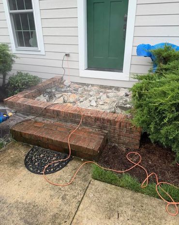 Old brick steps demolished at a green front door, Richmond VA – before