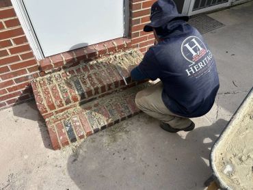Heritage mason repointing small brick steps at a side door, Richmond VA – before