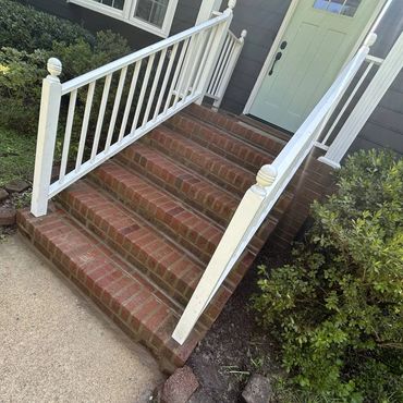 Front brick steps rebuilt between white railings, Richmond VA – after