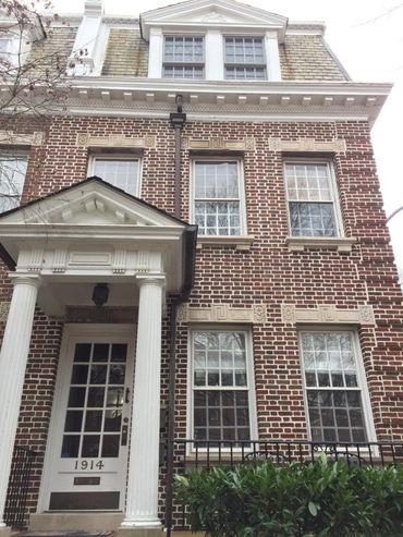Restored Georgian brick house facade with a white columned entry, Richmond VA