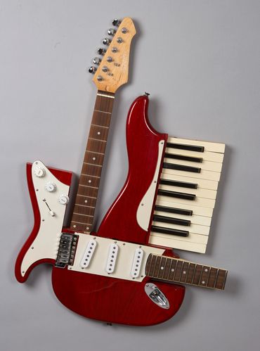 3D cubist sculpture of found objects mixes electric guitar an piano parts by artist dixon bergman