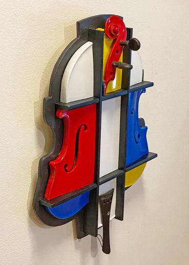 Left hand Side view of a 3D cubist sculpture decorated with a Mondrian inspired color scheme.