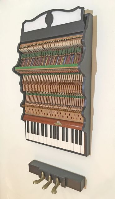 2-part wall hanging sculpture of piano parts in antique wood case