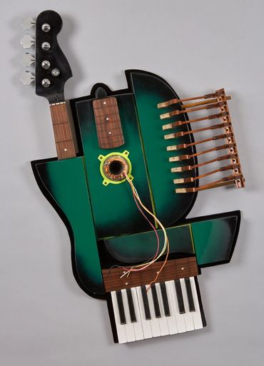 3D found objects sculpture by Dixon Bergman mixes guitar and piano parts with the guts of an electri