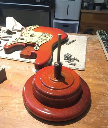 Base of the electric guitar sculpture is made of found electric lamp parts.