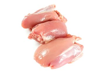 Three raw chicken thighs on a white background.
