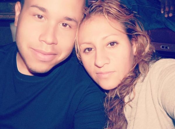 Close-up selfie of a couple smiling gently at the camera.