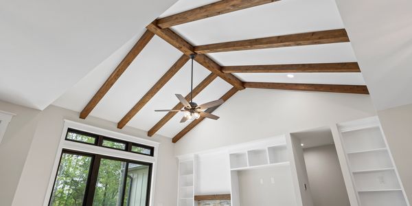 Custom cedar beams, which match the fireplace mantel, added a great detail to this living room.