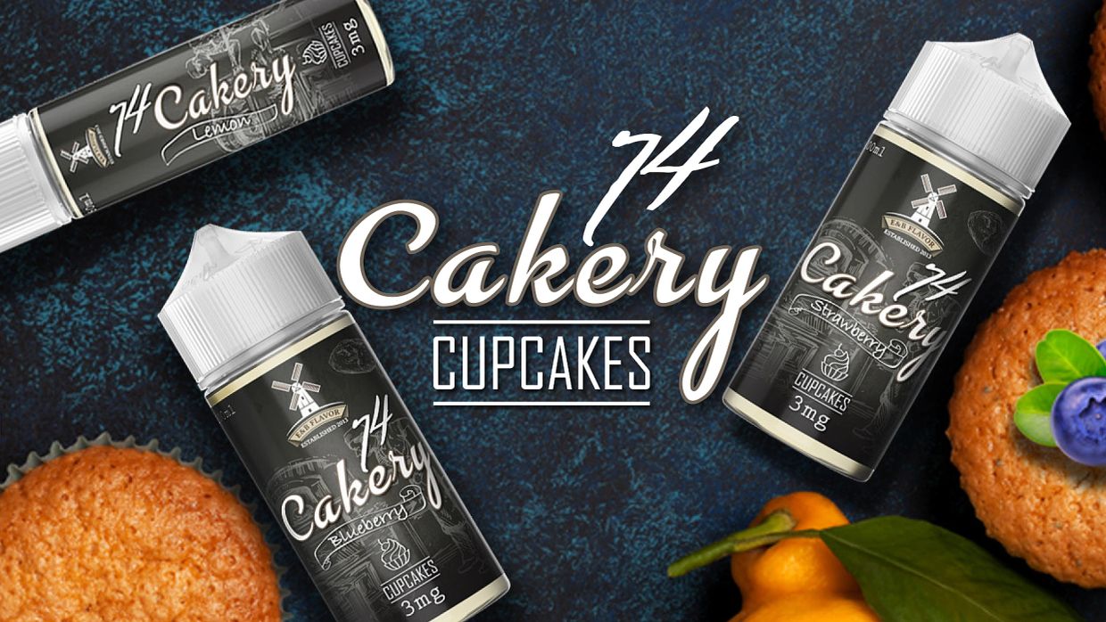 Bottles of 74 Cakery cupcake-flavored e-liquids on a textured surface.