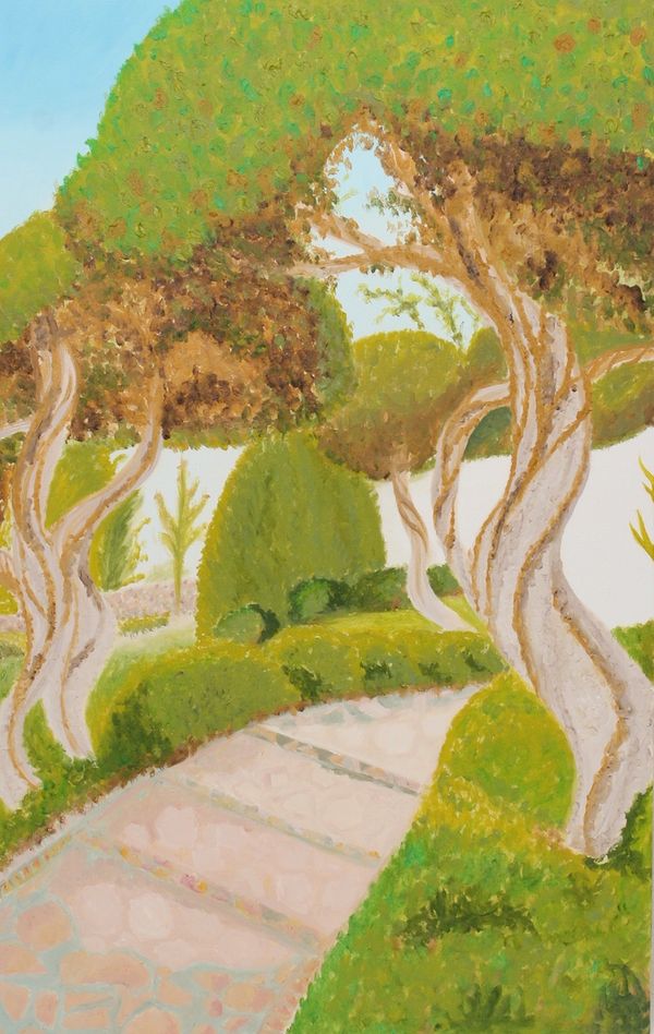 A winding garden path surrounded by trees and bushes.