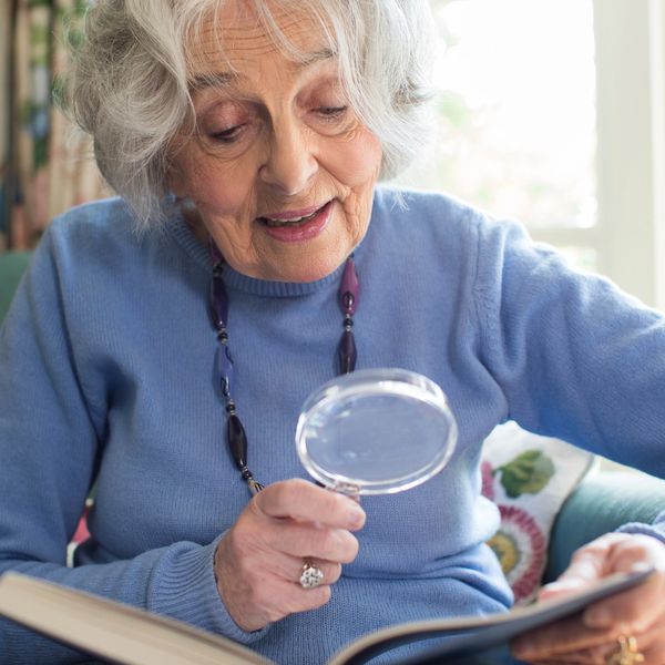 Lady reading with magnifier 