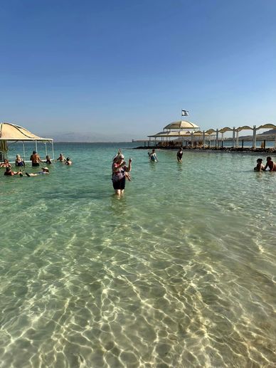 a group of people in the water at a beach