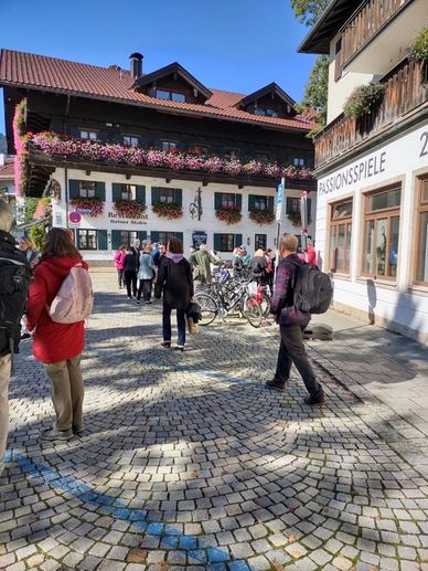 A group of people walking down a cobblestone street