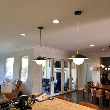 Modern living and dining room with pendant lights and cozy seating.