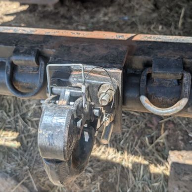 Close-up of a trailer hitch latch mechanism.