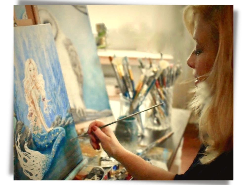 Artist, Nancy Quiaoit painting a mermaid.