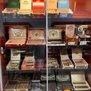 A display case filled with various cigar boxes and accessories.