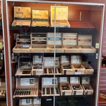Display case with various cigar boxes and accessories.